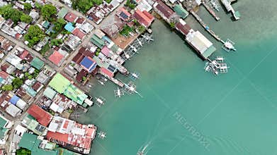 Push-in Bird-eye view shot over a coastal shanty town in the Philippines. The drone captur