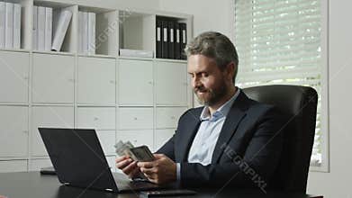 Office worker counting money after business deal. Banker counting money at corporate workplace. Man counting money with dollars in
