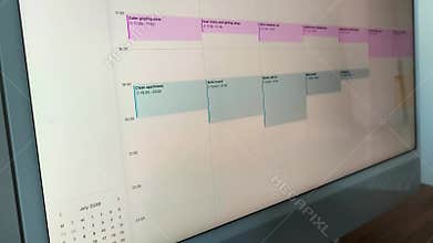 Panning shot across a colorful wall planner board. Sticky notes
