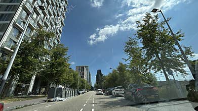 Modern high rise street scene in Amsterdam Zuid with parked cars, leafy