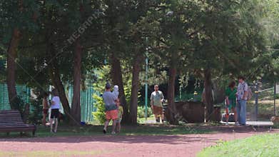 Happy families playing water fight in park