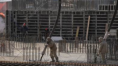 Workers work at building, fill in concrete