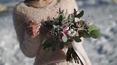 Bride with flowers outdoors at winter