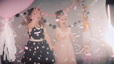 Children`s festival. Little Girl playing with paper confetti.
