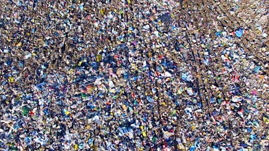 Piles of empty bottles, bags and other plastic in the garbage dump. Aerial.