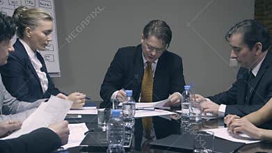 Mad boss yelling at employees and throwing papers