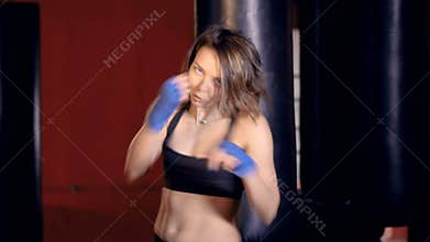 Young woman boxing looking at camera.