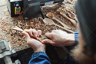 A man working with woodcarving instruments