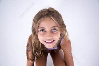 Happy blond girl looking at the camera from front