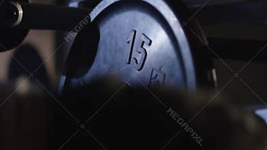 Preparing to bench press. Hands in chalk. With a barbell preparing different view. Vertically framed shot of an athletic