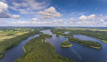 Aerial view of green islands and clouds at summer sunny day.Wydminy lake on Masuria in Poland.