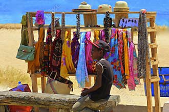 Young boy selling goods on the beach