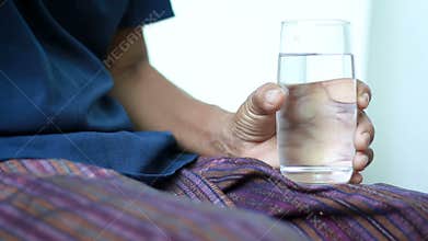 Hands of young woman holding and putting pill tablet medicine to Hands of old women concept for health care of old mother and yo