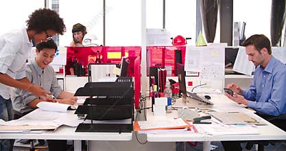 People Working At Desks In Modern Open Plan Office