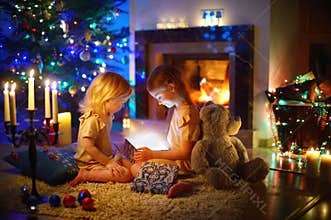 Little girls opening a magical Christmas gift