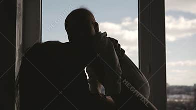 Silhouettes ofMmother and Baby near Window