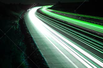 Road with car traffic at night with blurry lights