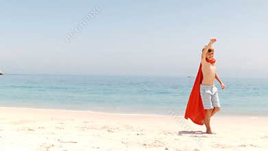 Little boy dressed as superman with towel
