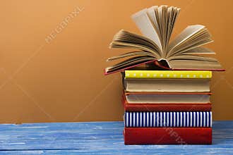 Open book, hardback books on wooden table. Back to school. Copy space for text