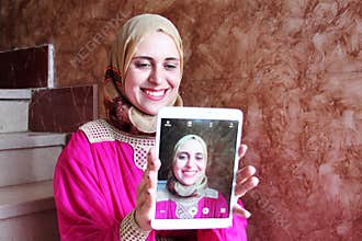 Selfie of happy arab muslim woman wearing hijab