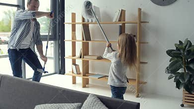 Cheerful father and daughter fighting with swabs