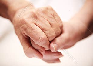 Adult helping senior in hospital