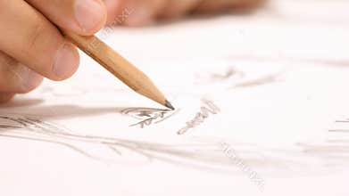 Close Up of Hand with Pencil Drawing Sketch on Paper