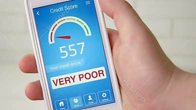 Checking credit score on smartphone using application. The result is VERY POOR