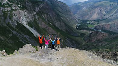 Successful Group of Happy Friends on Mountain Top, aerial slow motion 4k