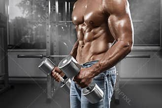 Muscular man working out in gym doing exercises with barbell, strong male naked torso abs