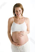 Pregnant woman holding exposed belly laughing