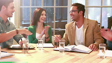 Casual businessman shaking hand during meeting