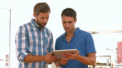 Casual businessmen using tablet computer