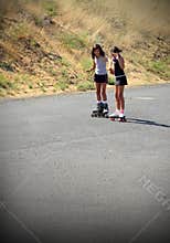 Girl Teaching Friend to Roller Skate