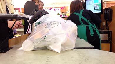 Customer paying for groceries at checkout counter