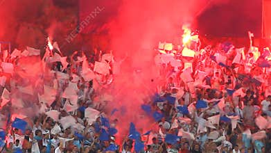 Soccer fans chant at the stadium