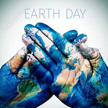 text earth day and man hands patterned with a world map (furnished by NASA)