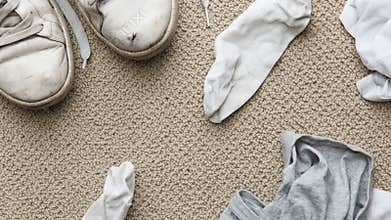 Messy bedroom floor of teenager doing sports