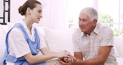 Senior man talking to nurse