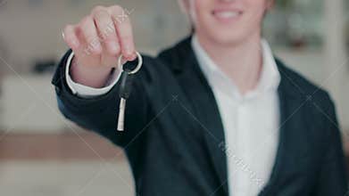 Close up of man's hand handing a car key
