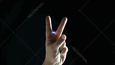 Hands showing victory. Electrostatics in male fingers