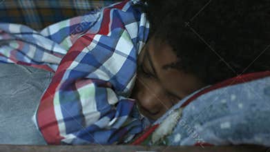 Young kid sleeping inside suitcase.