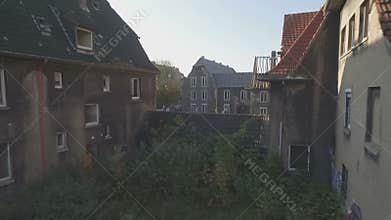 Aerial shot of a ghosttown,low altitude flight, medium tracking shot forward