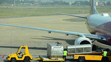 Vietnamese people loading baggage to store room of plane