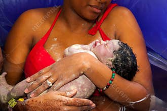 Mother Holding Her Newborn Baby After a Home Birth