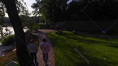 Two men walk in the park