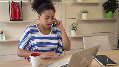 Attractive worker consults by cell customer.