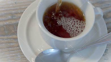 Pour tea into a cup 4K