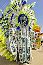 A tall male celebrant is dressed in Indian garb on Carnival Day in Trinidad