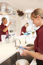 Commercial Cleaners Working In Kitchen